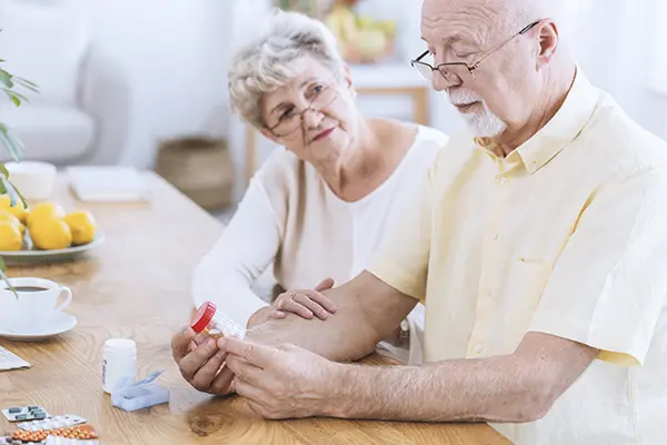 Senior couple looking at medications