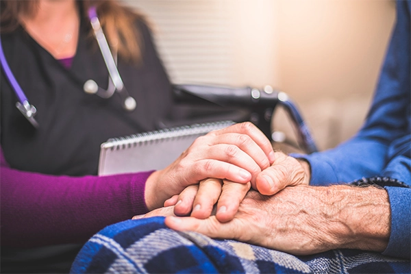Doctor comforting senior adult