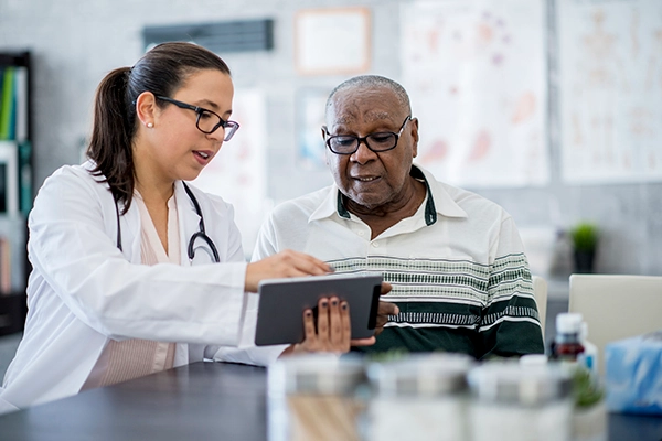 doctor explaining medication schedule to senior man