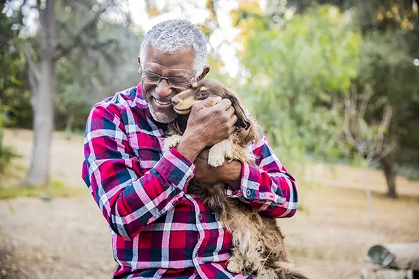 senior man playing with his dog