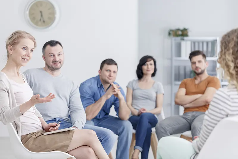 Therapist in group meeting