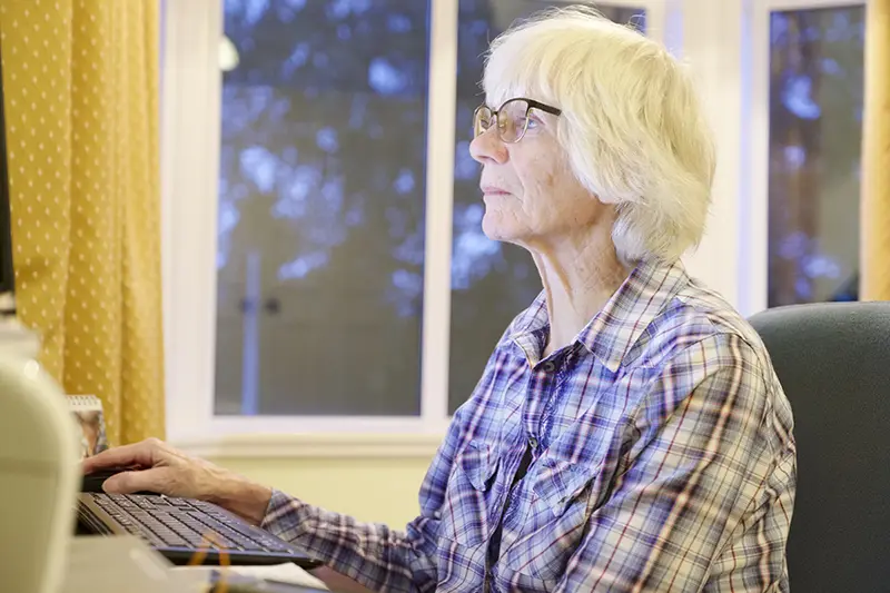 Senior old elderly person learning computer and online pension and banking internet skills protect against fraud