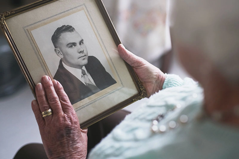 senior lady looking at old photo