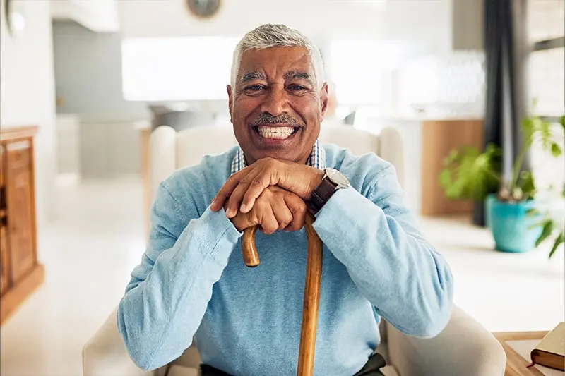 A senior who is scared of falling smiles after learning the best ways to avoid a fall.